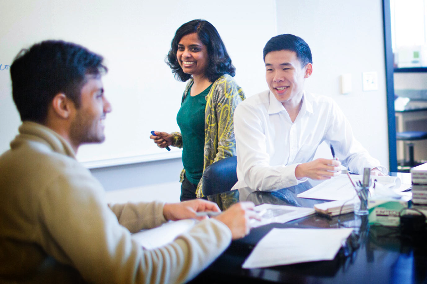 A professor assists two Oxford students