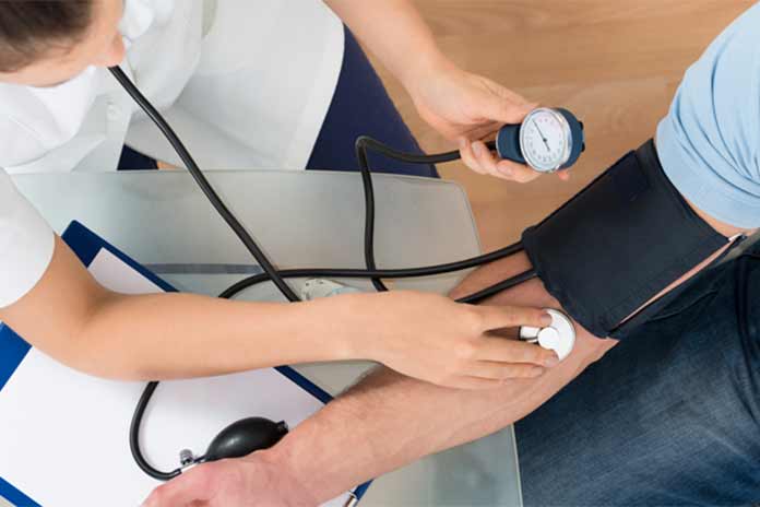 A healthcare working taking a patient's blood pressure