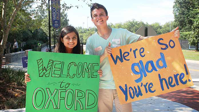 Oxford students holding welcome signs